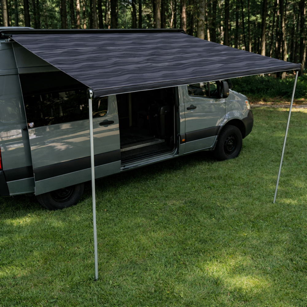 Side view of Vantrix manual RV awning showing adjustable support legs for stable outdoor shade