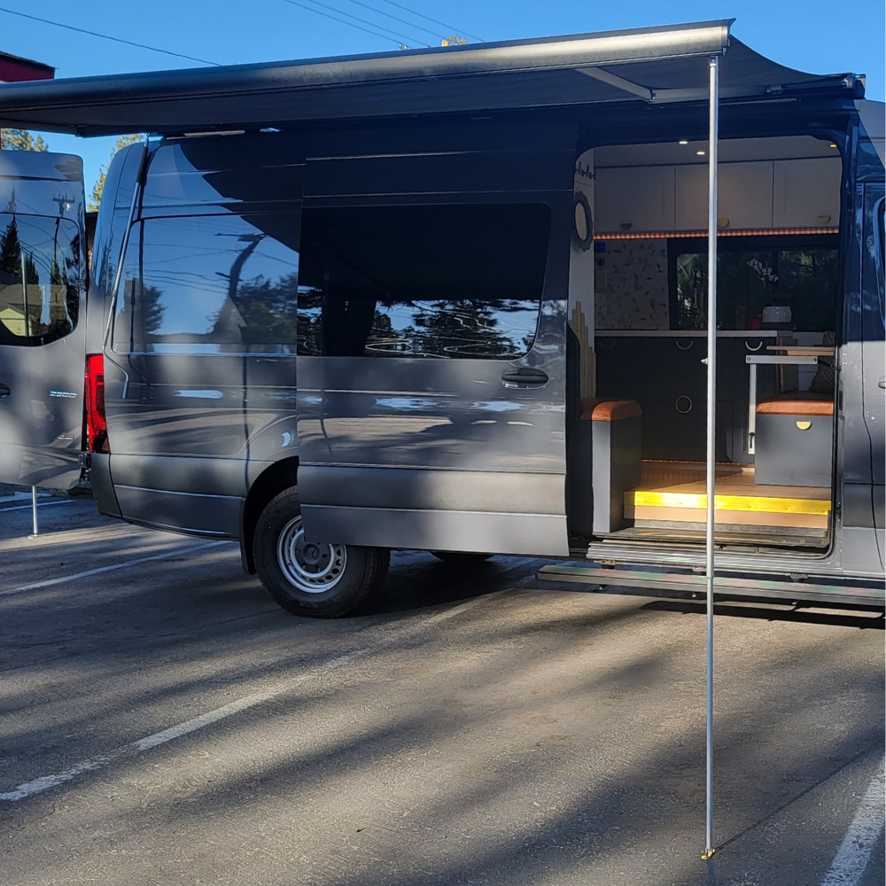 Vantrix manual awning extended for outdoor patio area in camper van roof rack installation