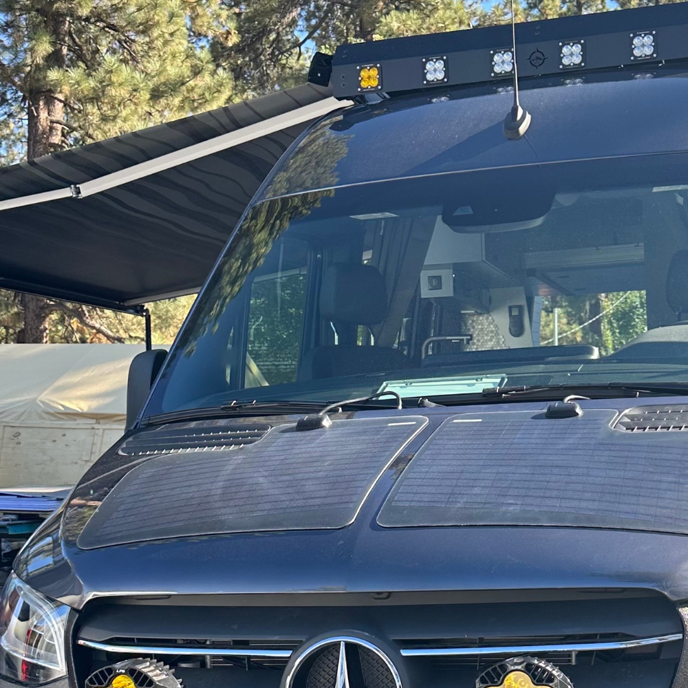 Vantrix manual side-mounted awning detail showing roof rack mounting hardware for Sprinter and Transit