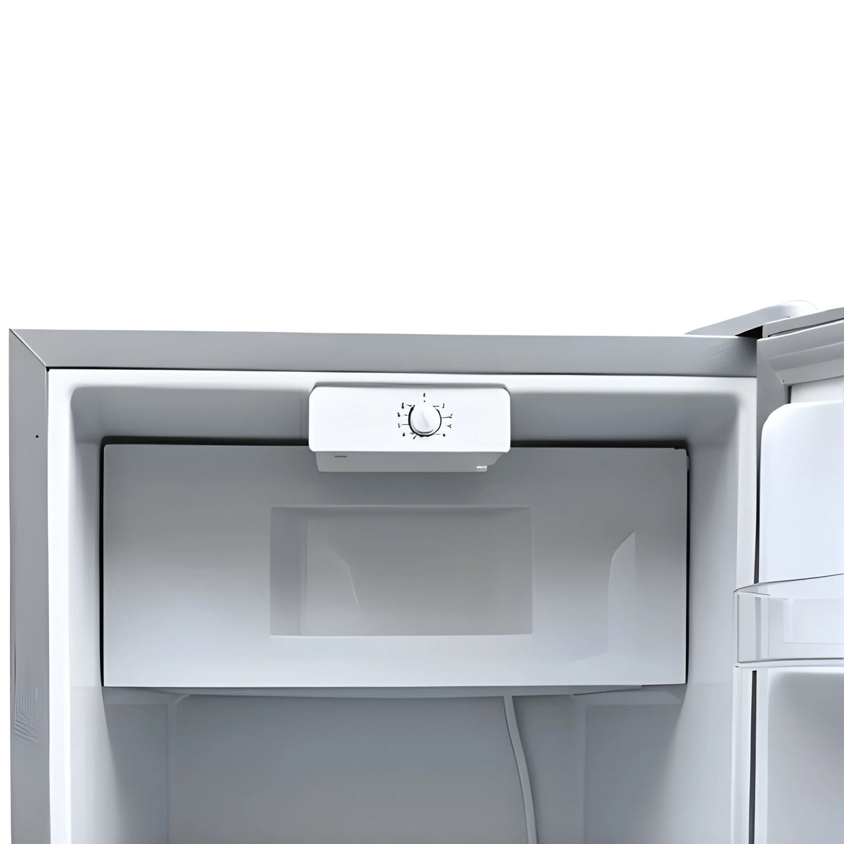 Close-up of the freezer compartment door and temperature control dial inside the Cryonex BC83A compressor fridge.