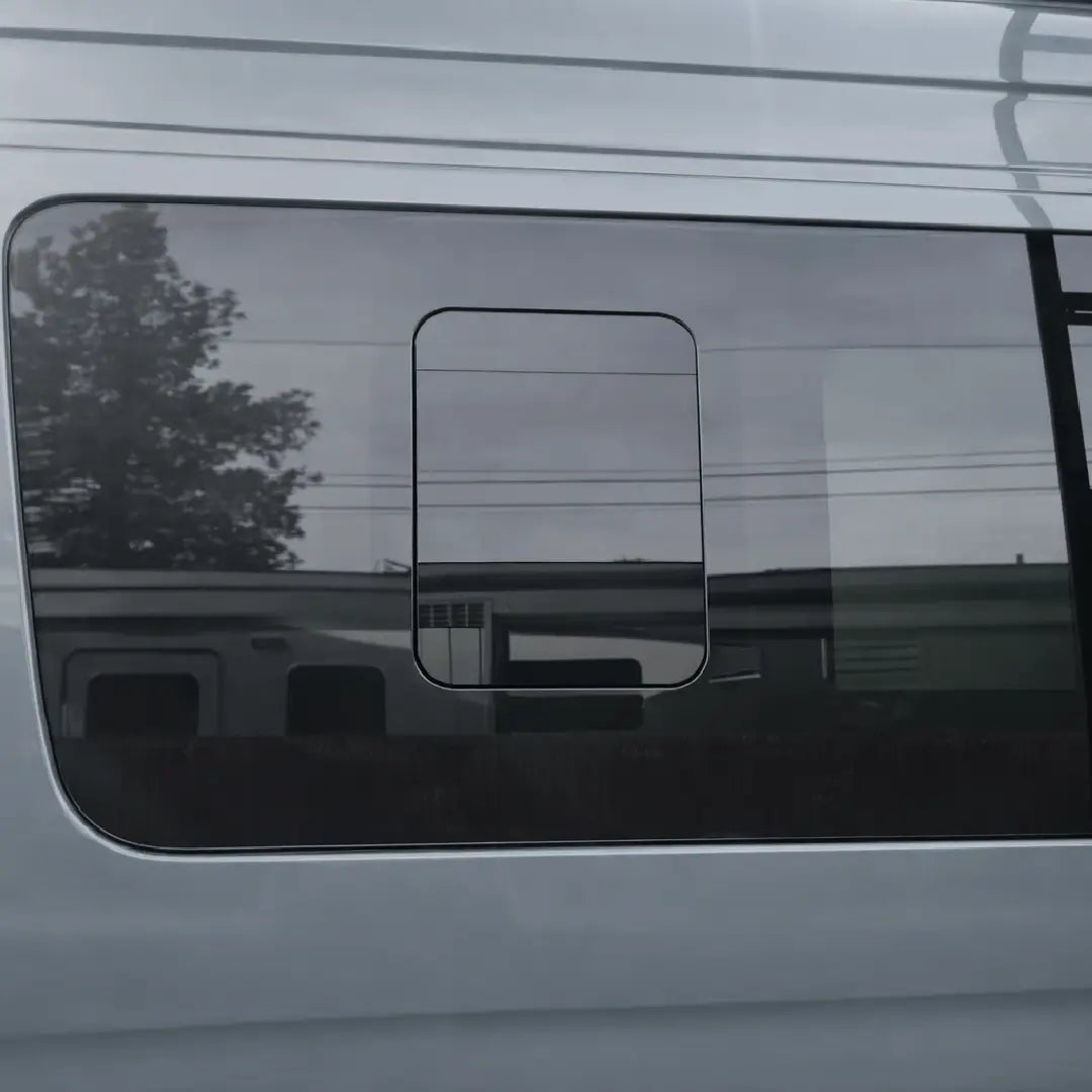 Glacier View driver-side front flush sliding window installed on a Mercedes Sprinter, showing tinted glass and the closed sliding panel.