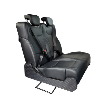 Three-quarter view of the NovaLux Duo RS double van seat with black cushions, shoulder belts and patterned side panels.