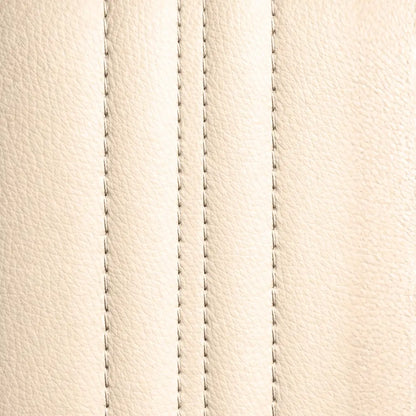 Close-up of the NovaLux Solo GT beige upholstery texture and parallel rows of stitching.