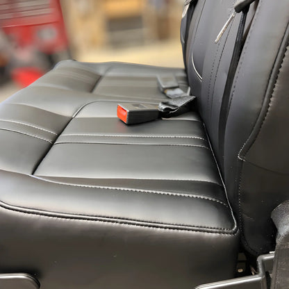 Detail of the NovaLux Classic double van seat cushion, upholstery stitching and red seat belt buckle.