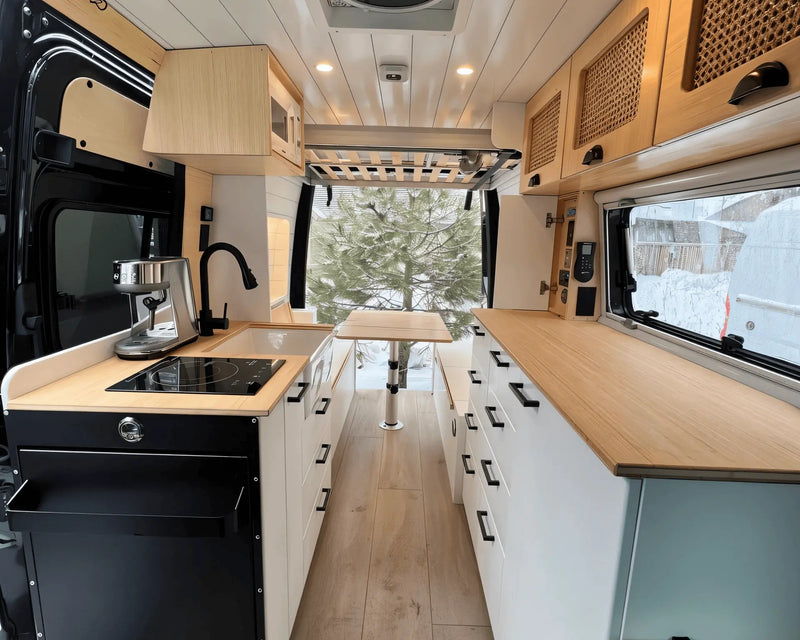 Experienced van builder inspecting a campervan electrical system in a custom conversion